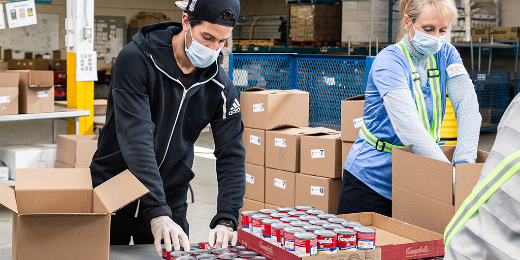 people sorting canned goods