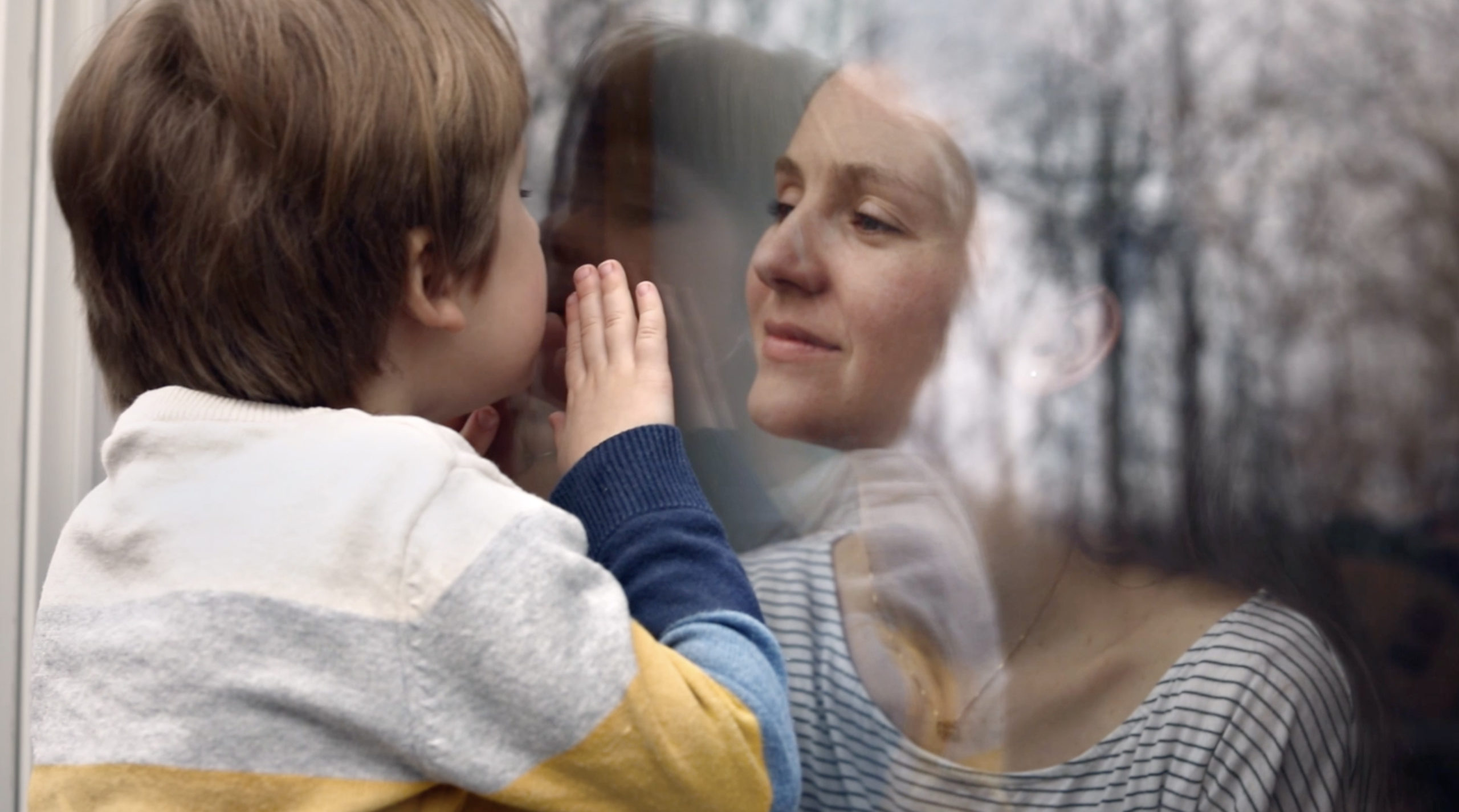 Child greets woman through window
