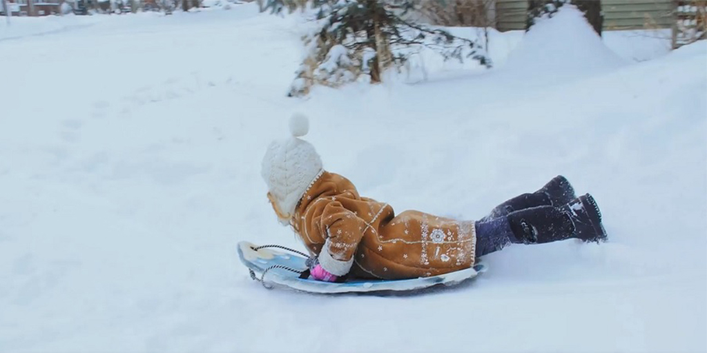 |child sledding|soup cans