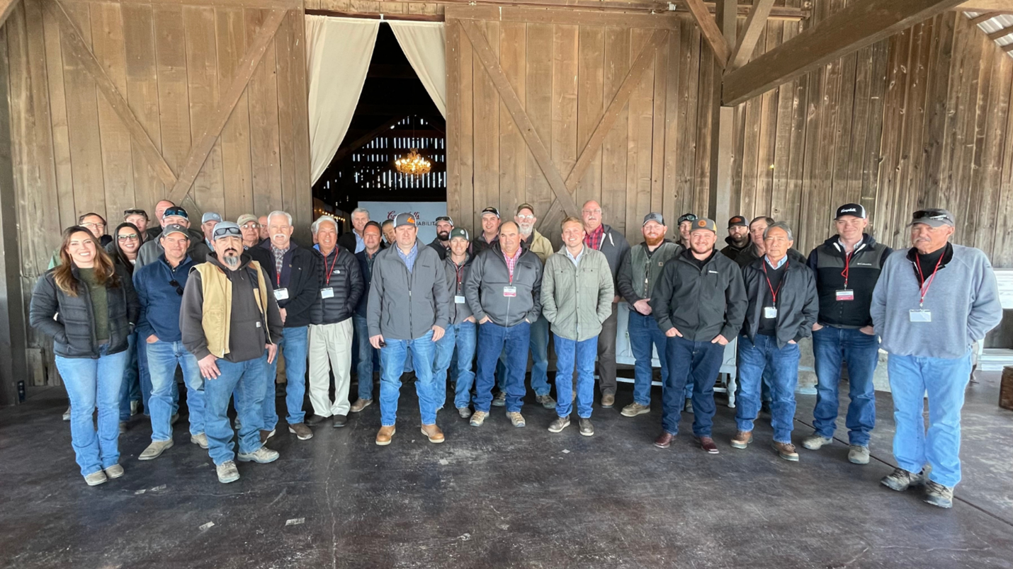 Tomato farmers standing outside barn
